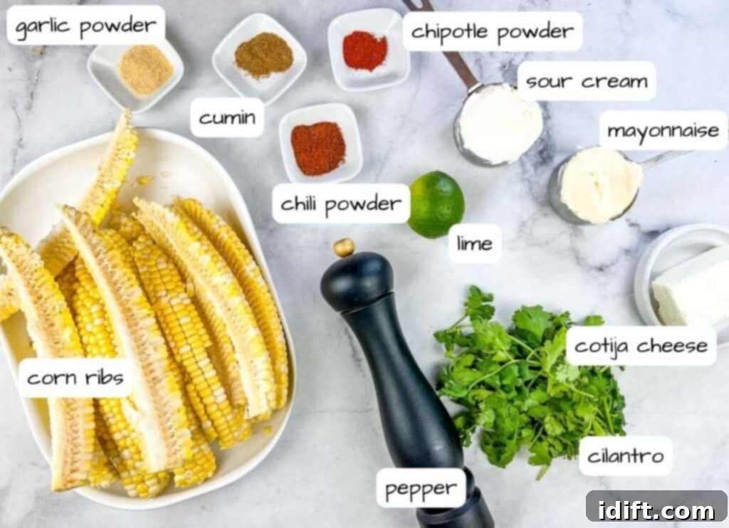 Ingredients laid out for making Grilled Elote Corn Ribs, including corn, spices, mayonnaise, sour cream, lime, and cheese.