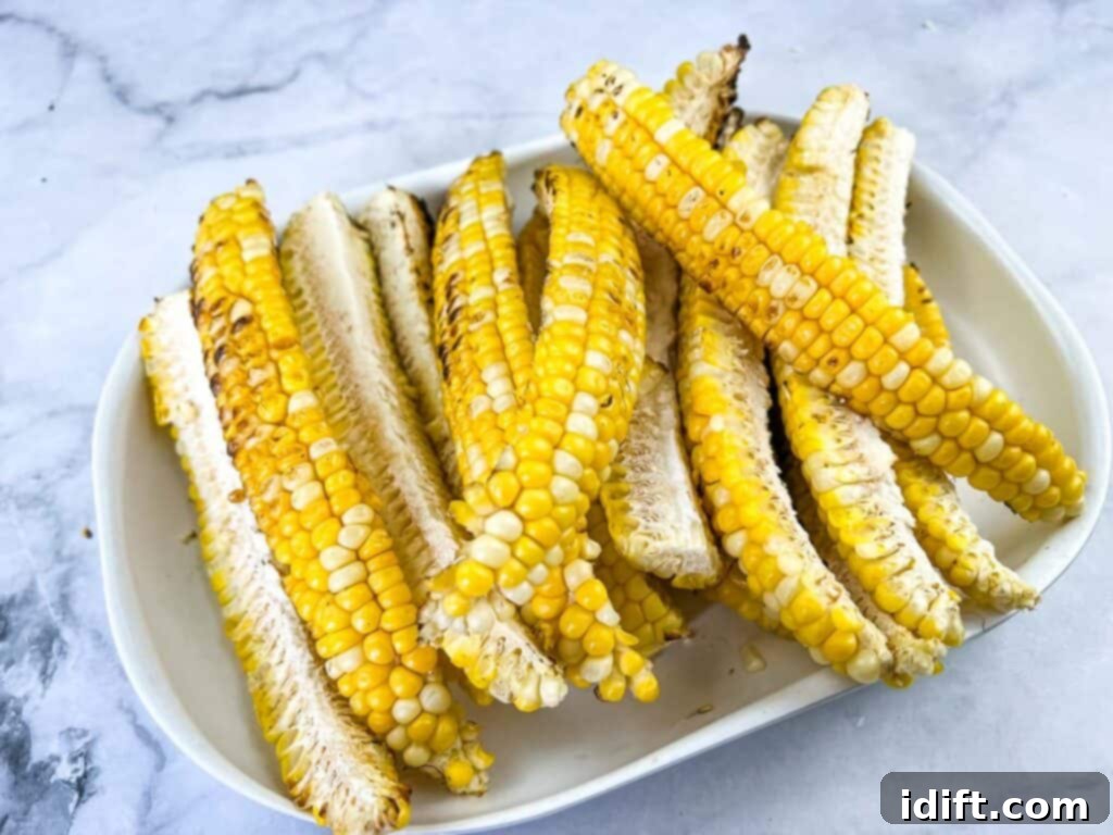 Grilled corn ribs arranged neatly on a plate, showing their unique curved shape and char marks.