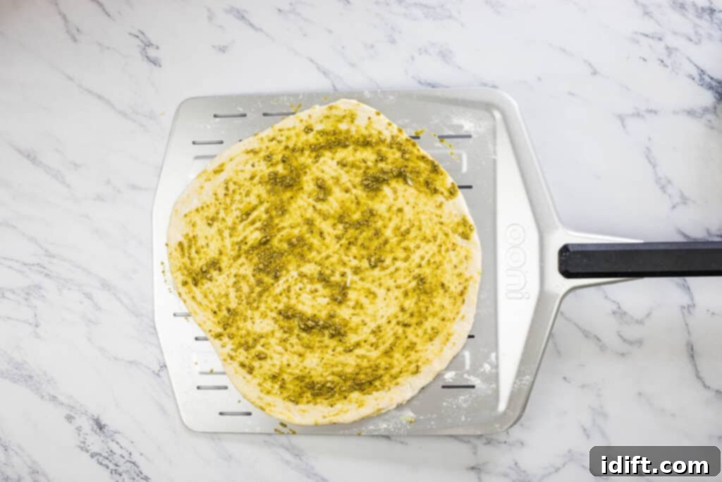 Asparagus and Prosciutto Masterpiece 9 Pizza dough topped with pesto sauce.