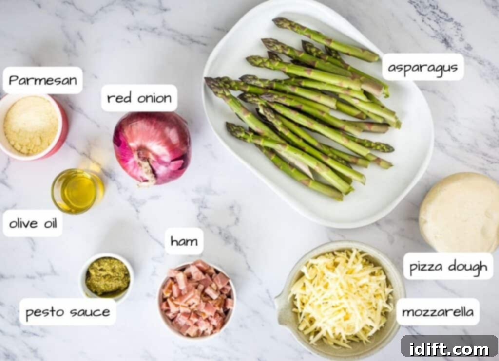 Asparagus and Prosciutto Masterpiece 5 Labeled ingredients laid out on a table, including pizza dough, pesto, mozzarella, ham, asparagus, and red onion, ready for making Ham & Asparagus Pizza.
