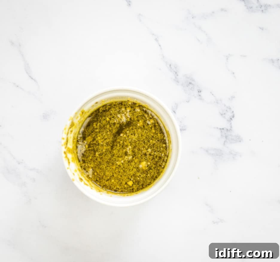 Asparagus and Prosciutto Masterpiece 7 Mixing pesto sauce with olive oil in a bowl.