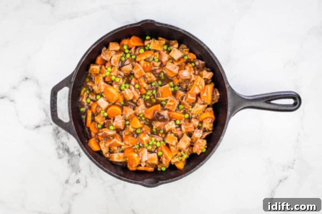 The filling loaded into a baking dish, forming the base of the pie.