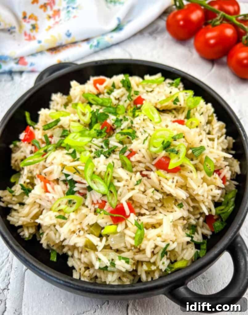 Vibrant Mediterranean Rice 2 Mediterranean Rice in a black serving bowl, garnished with fresh herbs.