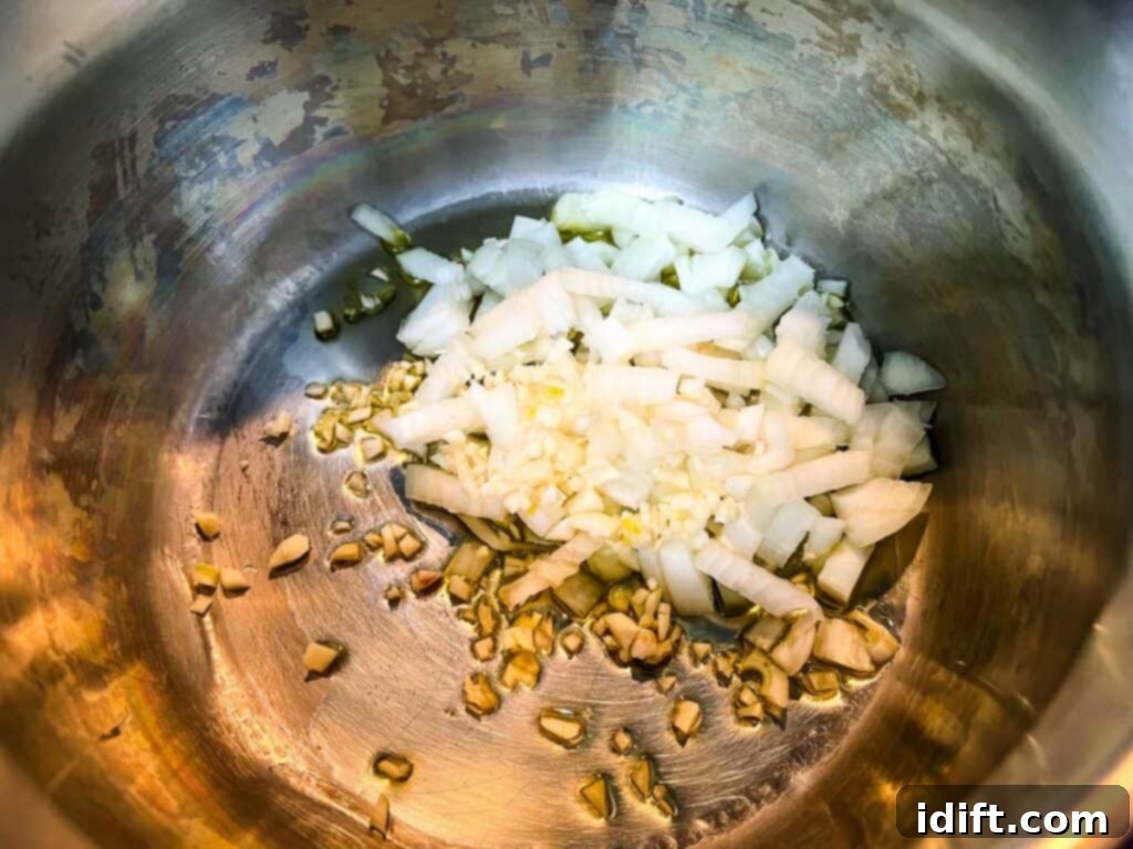 Vibrant Mediterranean Rice 7 Onions and garlic in a saucepan, beginning to soften.