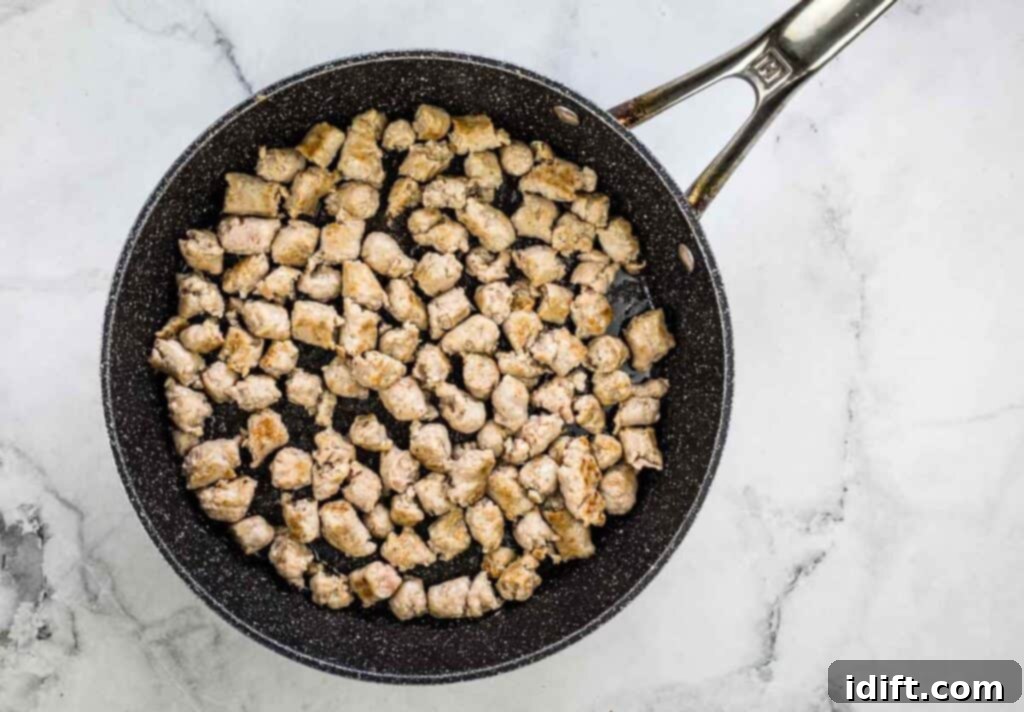 Sausage browning in a skillet.