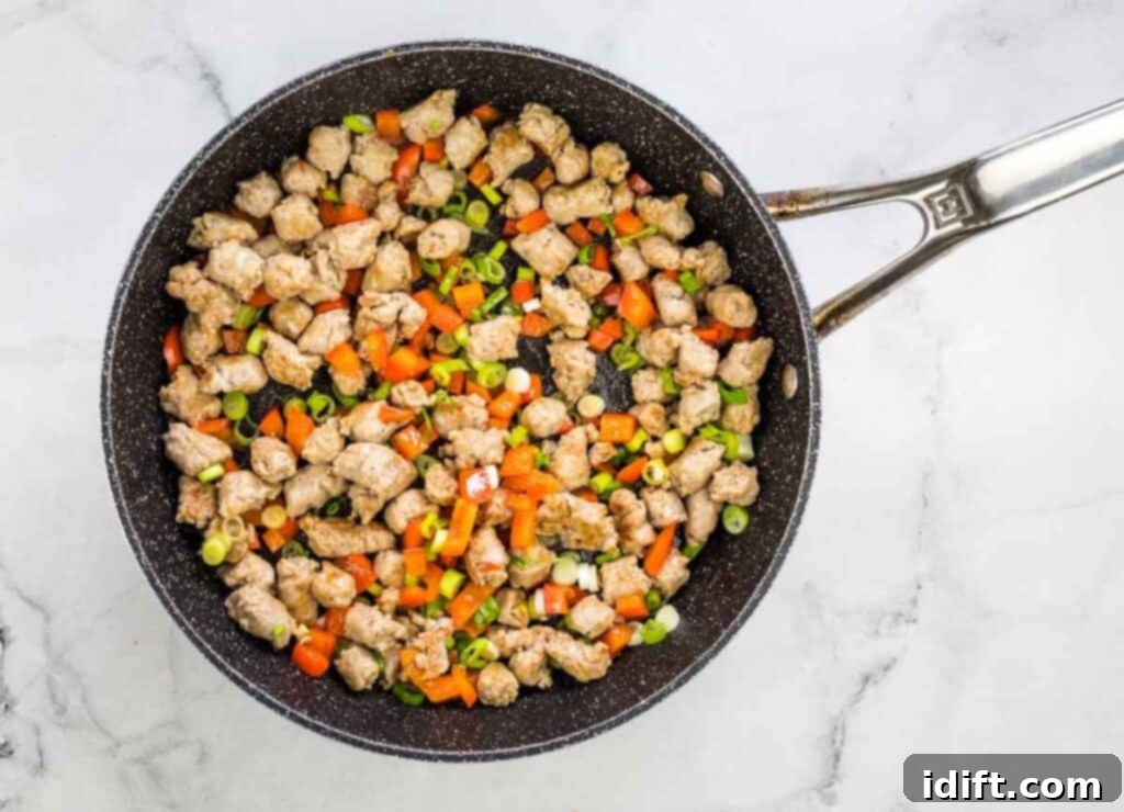 Red pepper and green onion added to skillet.