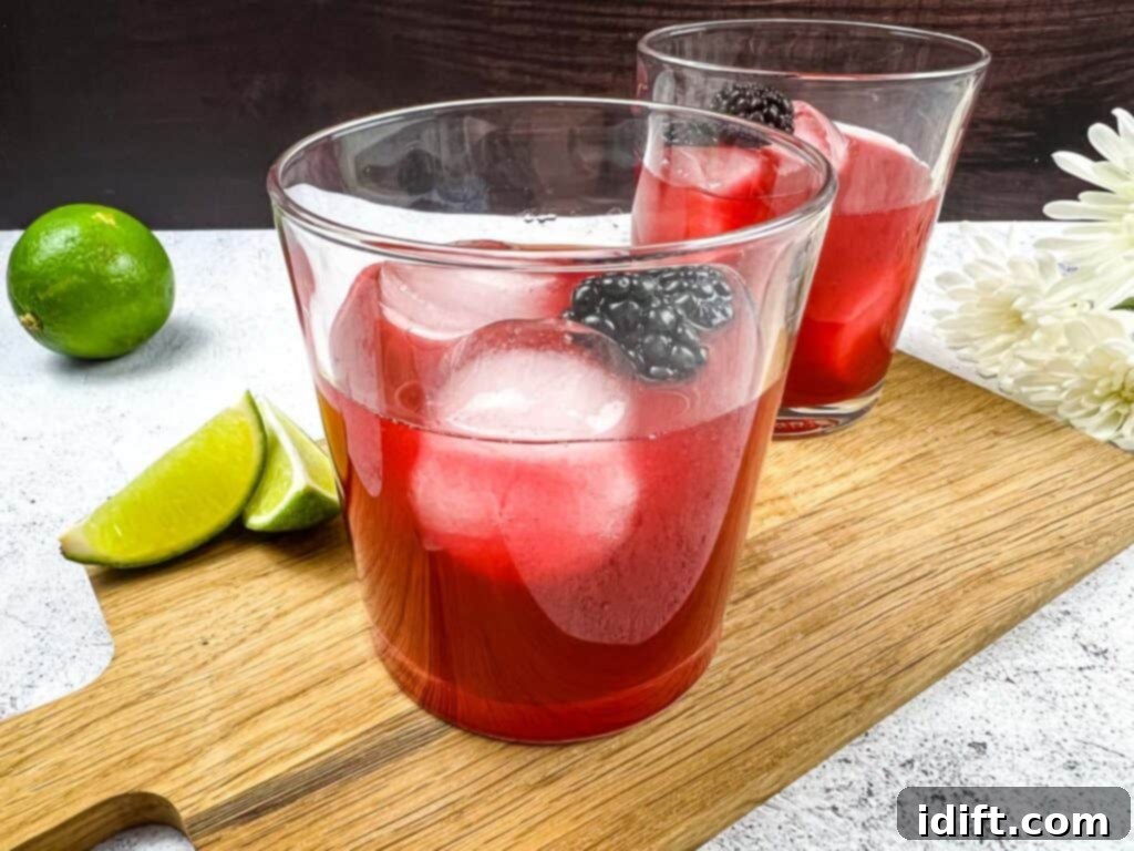 Smoked Blackberry Margarita ingredients being added to a cocktail shaker, prior to mixing and straining.