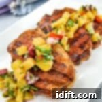Ninja Woodfire Grill Pork Chops with Pineapple Salsa on a white plate.