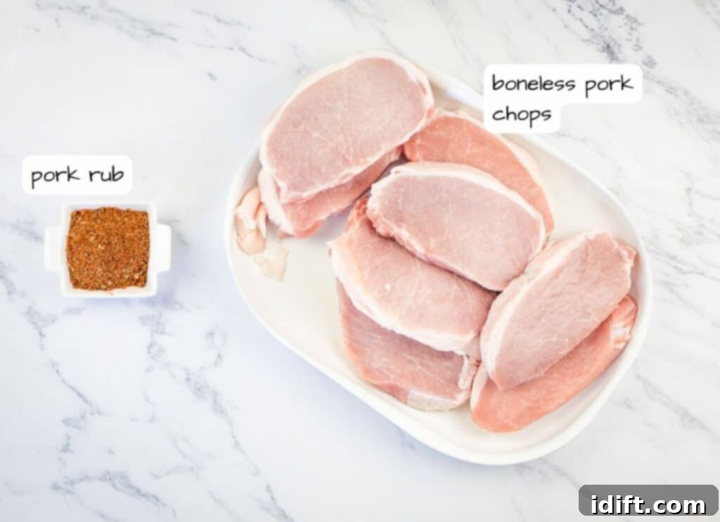 Clearly labeled ingredients for the grilled pork chops, including boneless pork loin chops, a bowl of sweet & spicy rub, salt, and pepper.