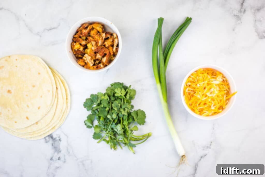 Ingredients for Al Pastor Chicken Quesadillas laid out: tortillas, shredded cheese, cooked Al Pastor chicken, green onions, and cilantro.