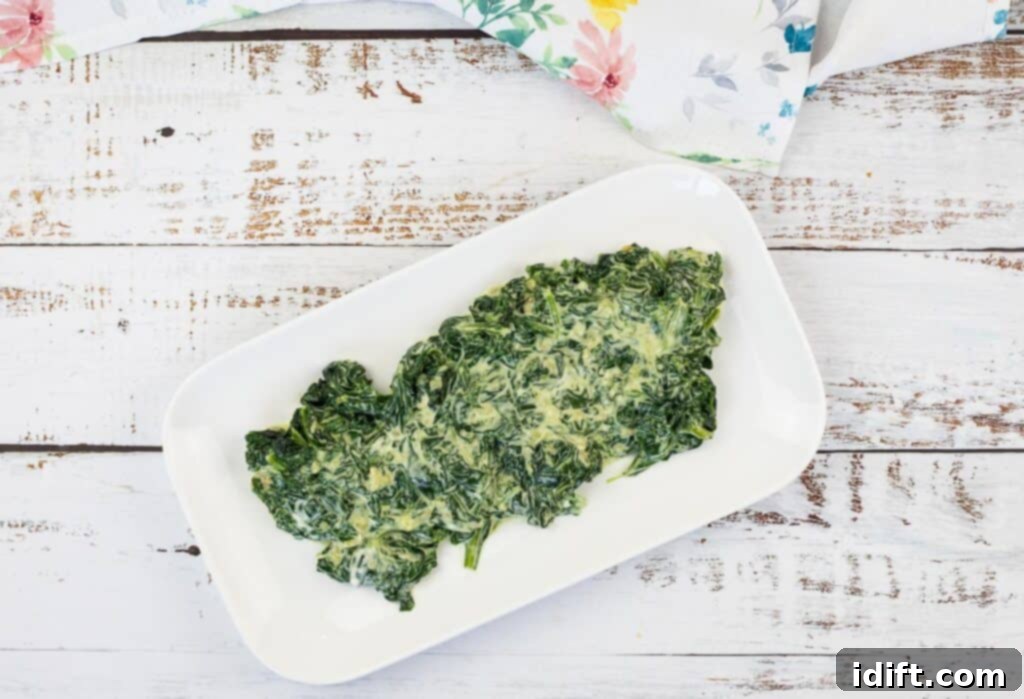 Velvet Mascarpone Spinach Your Ultimate Creamy Side 4 A top-down shot of Creamed Spinach with Mascarpone in a white dish, ready to be served.