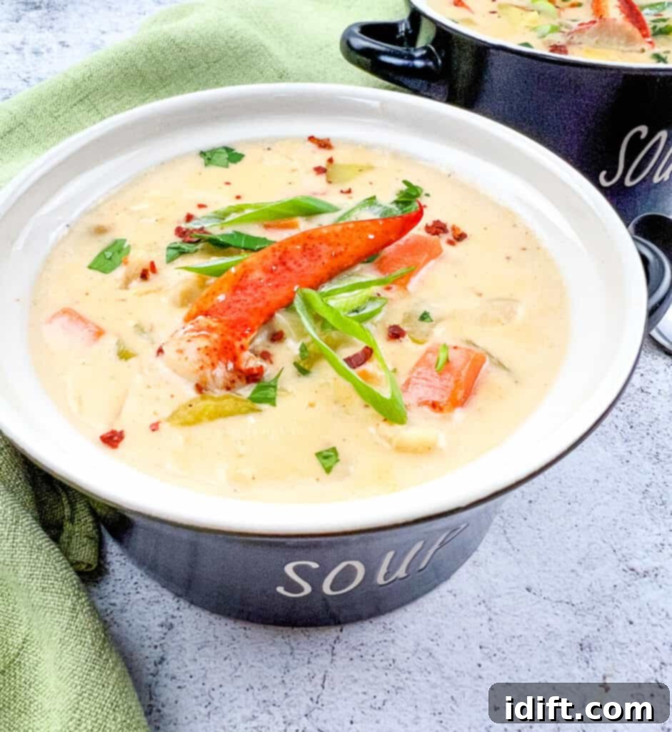 Lobster chowder in a black soup bowl.