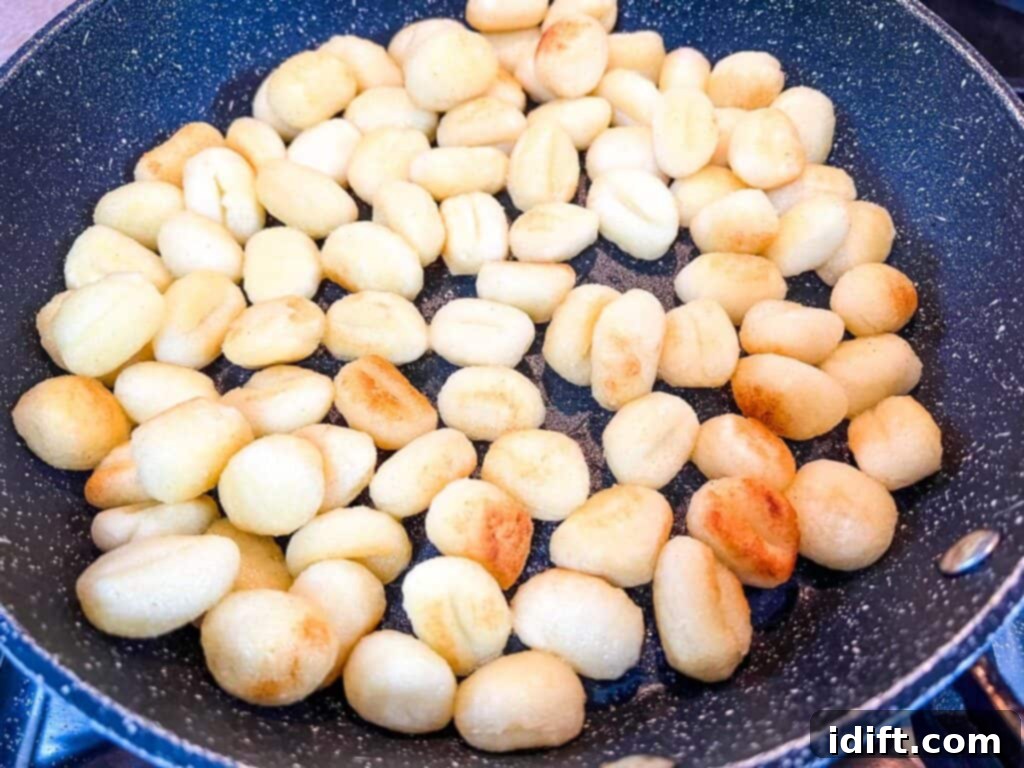 Browning the gnocchi in a skillet with butter.