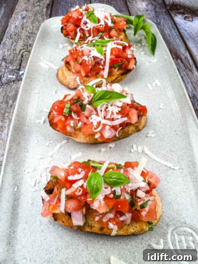Effortless Bruschetta Bites 2 Tomato Bruschetta on a plate.