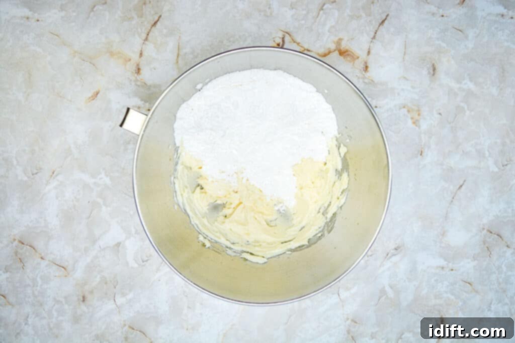 Autumn Fudgy Brownie Bites 16 Whipped butter in a mixing bowl, followed by the addition of powdered sugar, creating the base for a smooth and creamy buttercream.