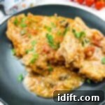 Slow Cooker Swiss Pork Chops on a black plate.