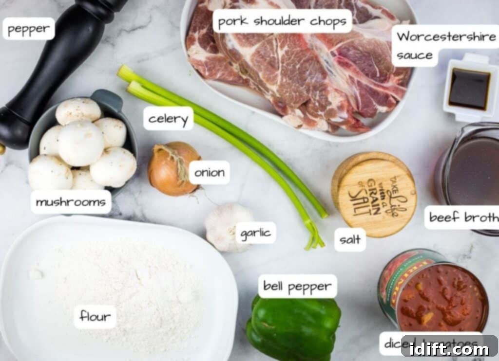A collection of fresh ingredients laid out, ready to make Swiss Pork Chops, including pork chops, vegetables, and canned goods.