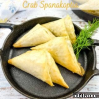 Mediterranean Spaghetti Delight 6 A serving of savory crab spanakopita on a sleek black plate, garnished with fresh herbs.