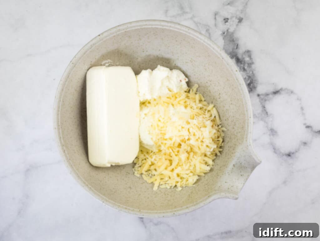 Priceless Pasta Bake 8 A bowl with cream cheese, parmesan cheese, and ricotta.