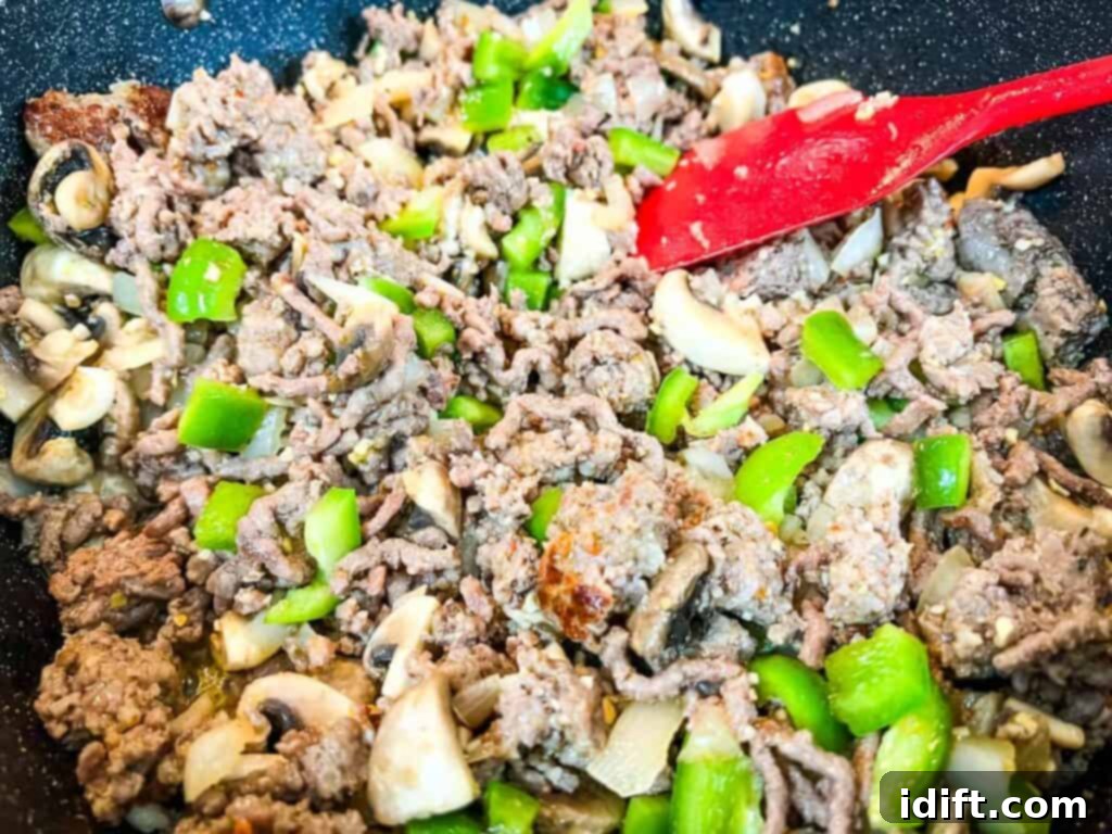 Priceless Pasta Bake 11 A pan with meat and vegetables in it.