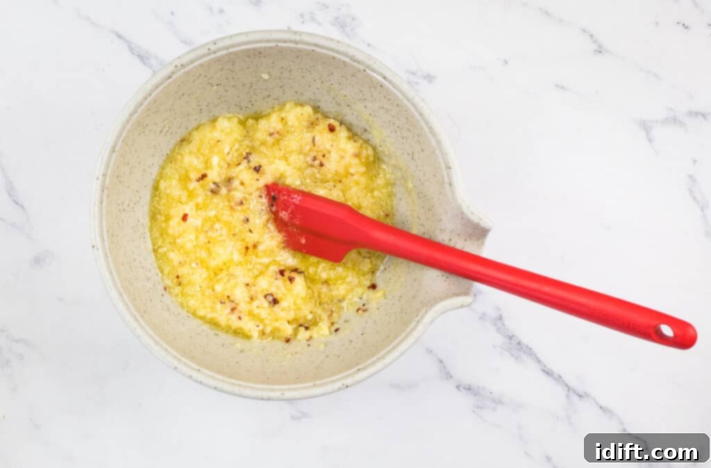 Irresistible Smoked Garlic Parmesan Wings 9 A bowl with melted butter and garlic in it.