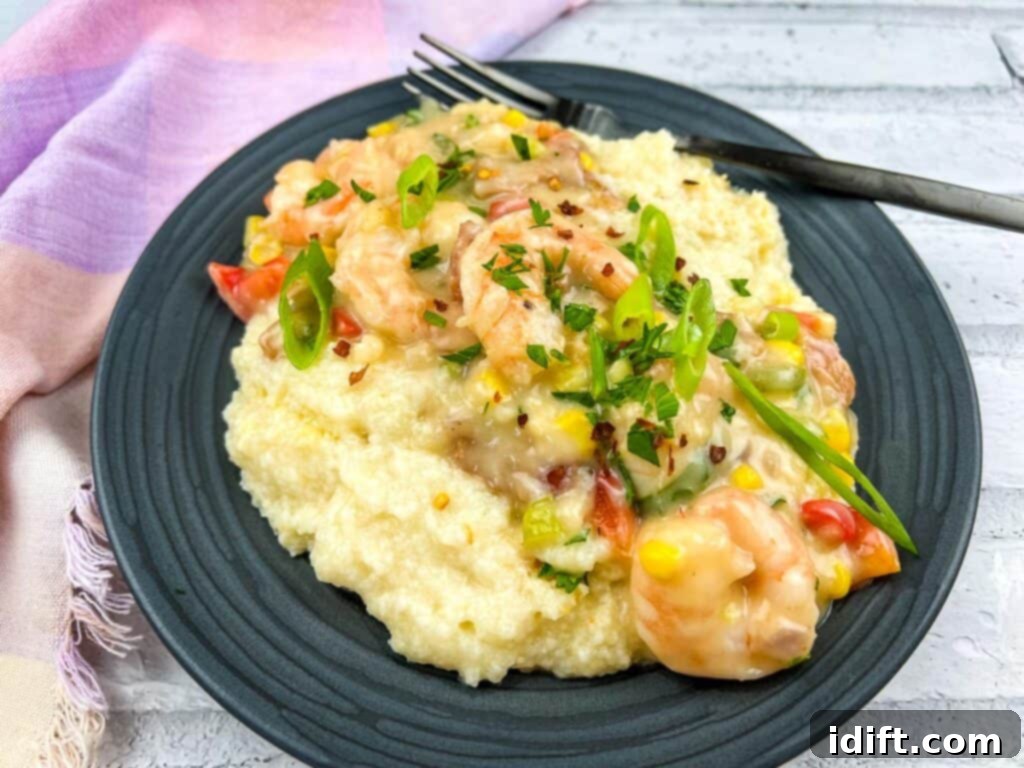 Comforting Baked Shrimp and Grits Casserole 6 A serving of shrimp and grits casserole on a plate with a fork, ready to be enjoyed.