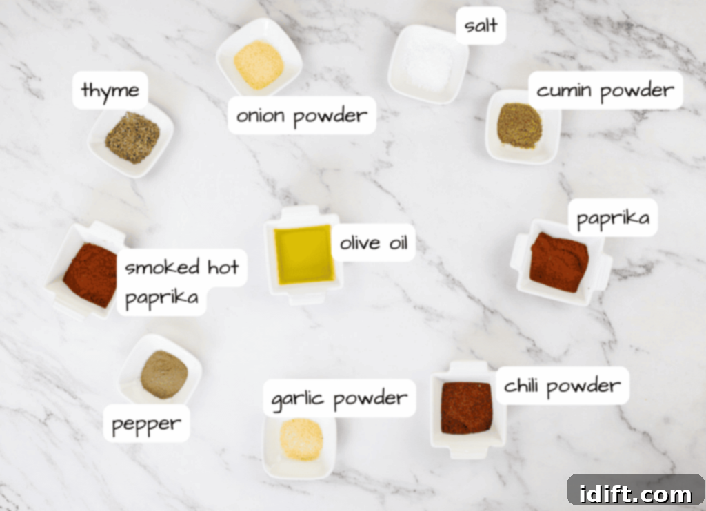 Assortment of vibrant spices and seasonings in small bowls on a marble table.