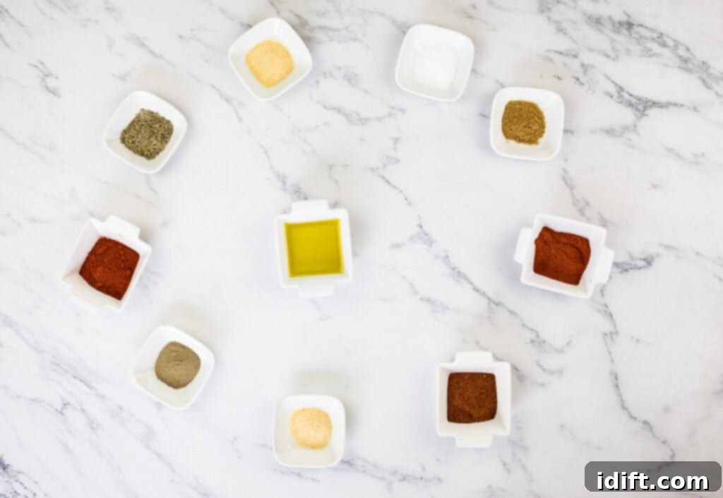 Spices for the dry rub arranged in a circle on a marble table.