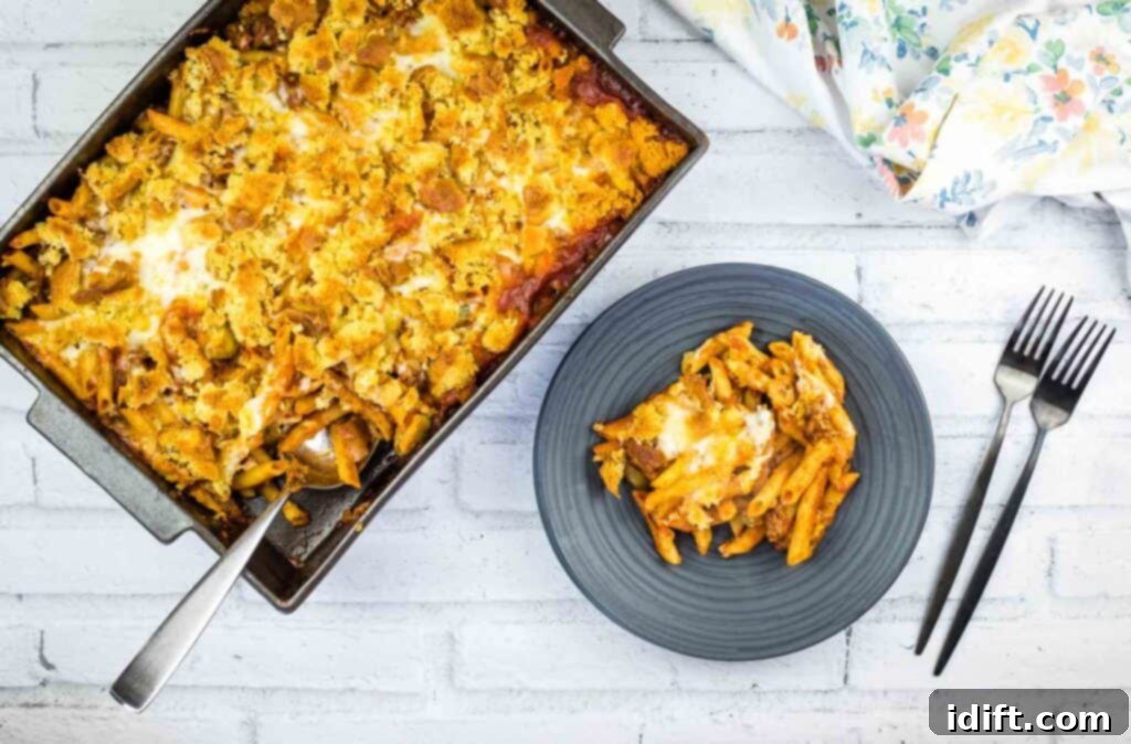 Hearty Sloppy Joe Noodles 5 A close-up of a serving of Sloppy Joe pasta casserole in a ceramic dish, showing the rich meat sauce, tender pasta, and golden cheese topping, ready to be enjoyed.