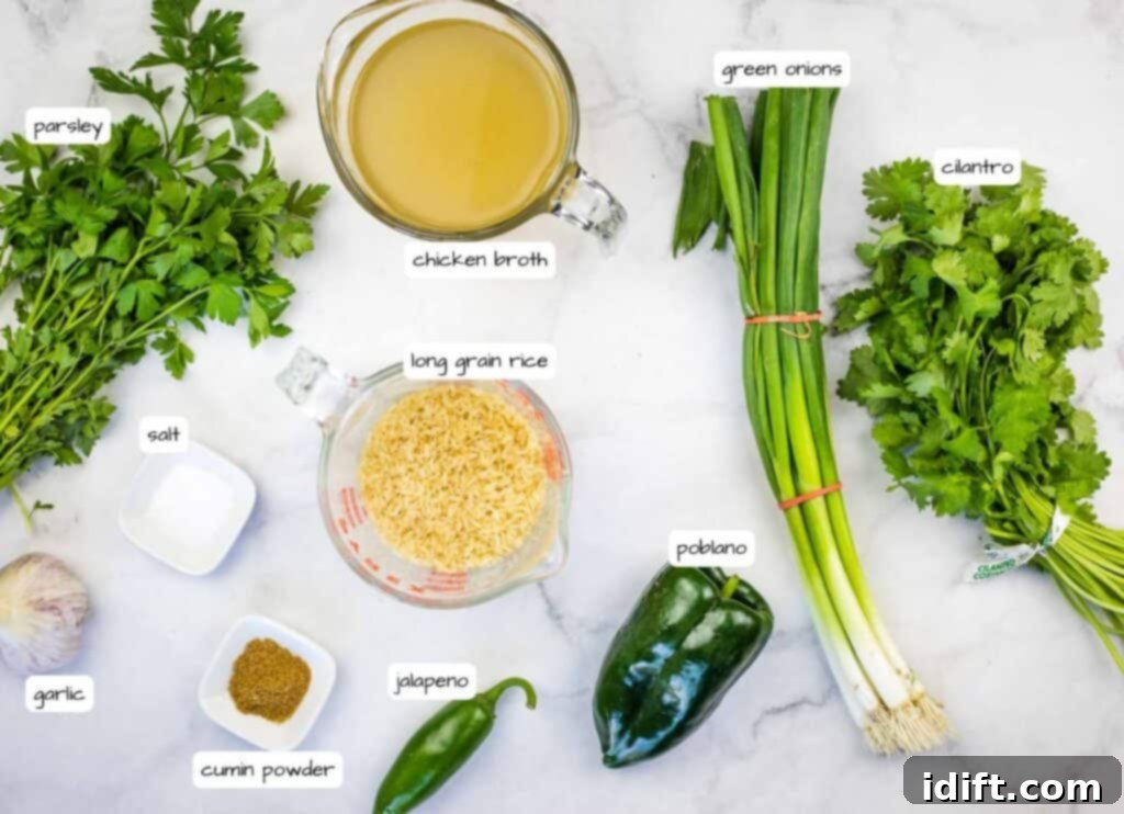 Emerald Herb Rice 4 Assorted fresh ingredients for Arroz Verde neatly arranged on a white surface, including vibrant parsley, cilantro, green onions, uncooked long grain rice, a container of chicken broth, a small bowl of cumin powder, salt, garlic cloves, and two peppers: a bright green jalapeño and a darker green poblano pepper.