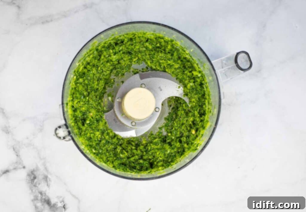 Emerald Herb Rice 5 A vibrant green herb and chili puree is being blended in a food processor, ready to infuse flavor into the rice.