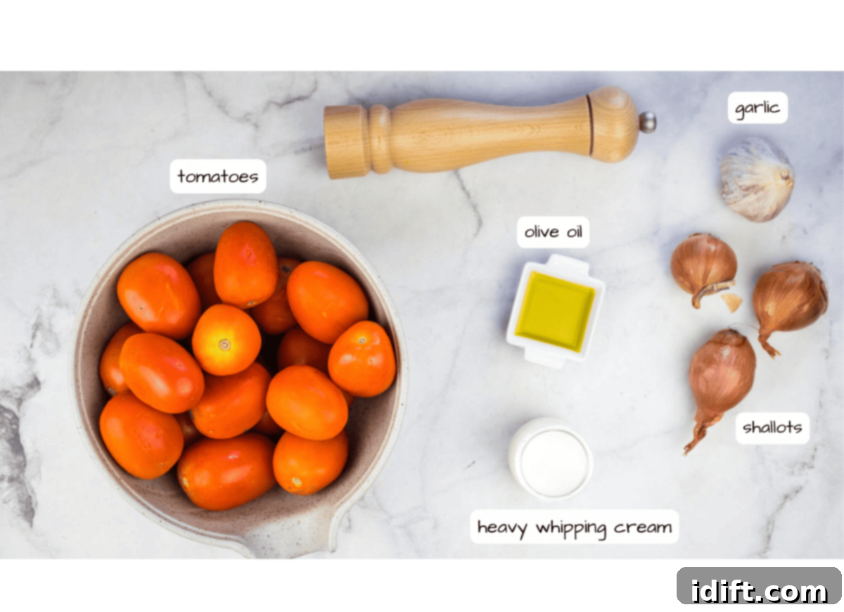 Labeled ingredients for oven roasted tomato soup, including tomatoes, shallots, garlic, olive oil, and cream.