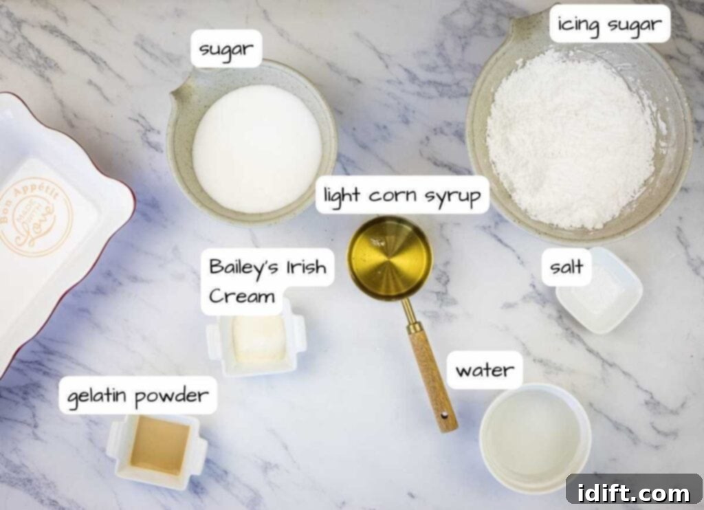 The ingredients for delicious homemade Baileys marshmallows are displayed on a marble countertop.