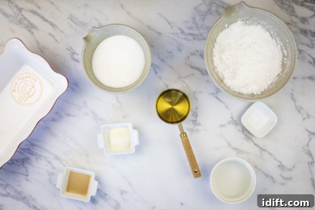 Sugar, flour, eggs and other ingredients on a marble counter for making marshmallows.