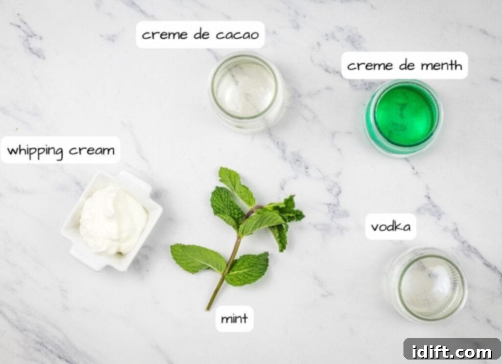 The ingredients for a mint cream are neatly displayed on a marble table, ready for crafting the Whoville Martini.