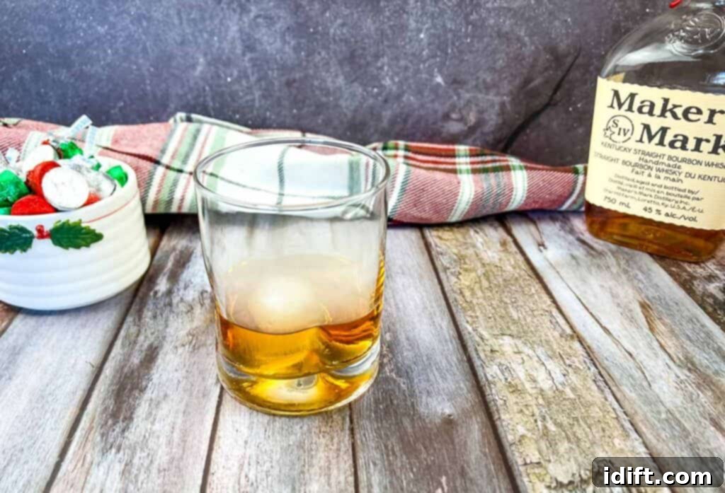 A glass of whiskey and a bottle of Maker's Mark, illustrating the quality ingredients.