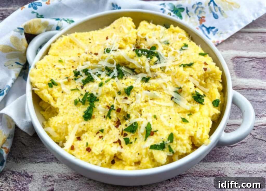 Polenta with mascarpone in a white bowl with parmesan cheese.