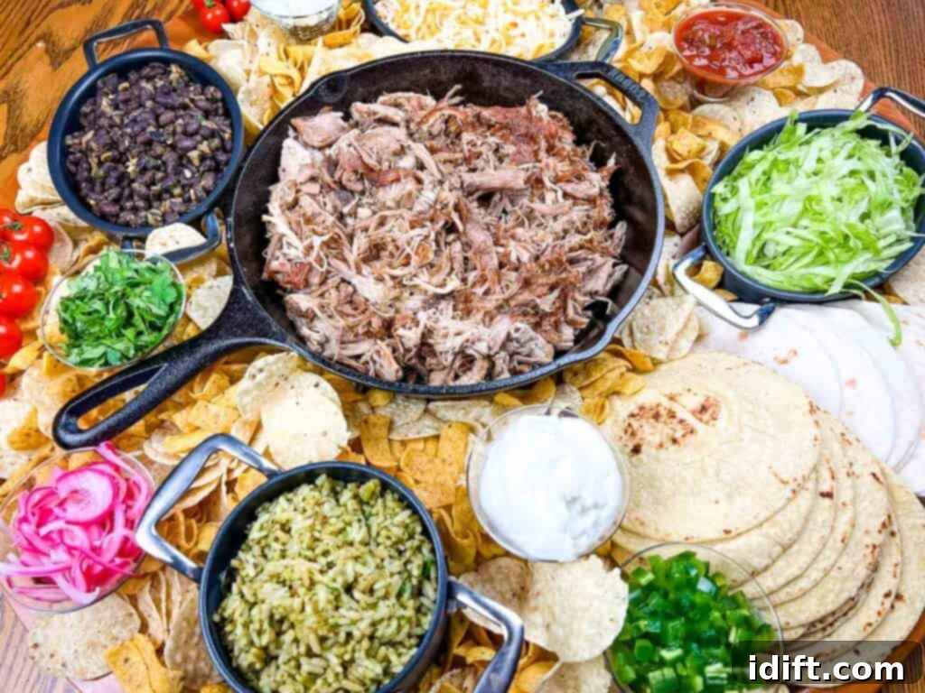 The Perfect Slow Cooker Pork Carnitas Spread 3 A platter of mexican food on a wooden table.