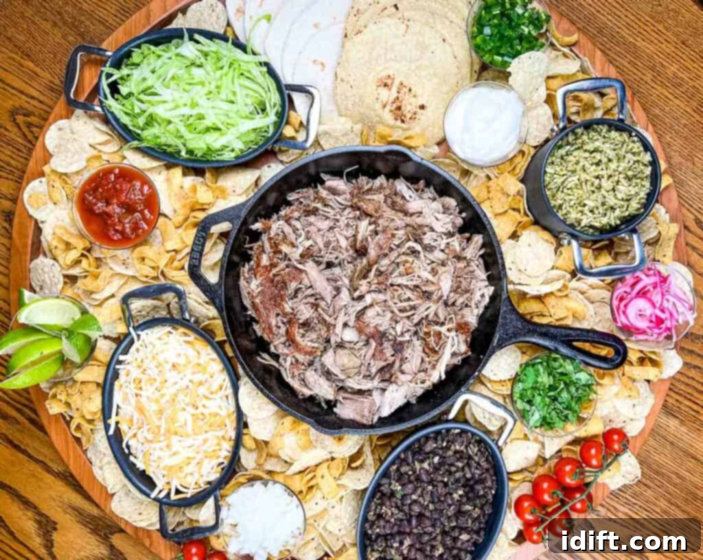The Perfect Slow Cooker Pork Carnitas Spread 5 A platter of mexican food on a wooden table.