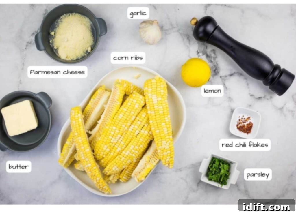 A vibrant selection of fresh ingredients including corn cobs, butter, garlic, lemon, parsley, and red chili flakes, ready for cooking.