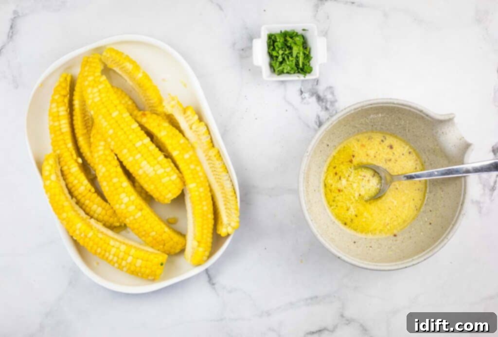 Cooked corn ribs in a bowl, being tossed with the prepared garlic-Parmesan sauce.