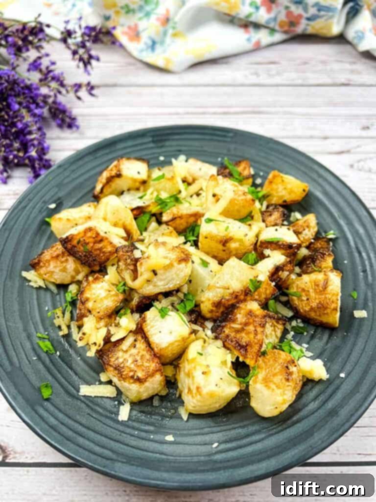 Golden Parmesan Roasted Kohlrabi 2 A plate with roasted kohlrabi and parmesan on it.