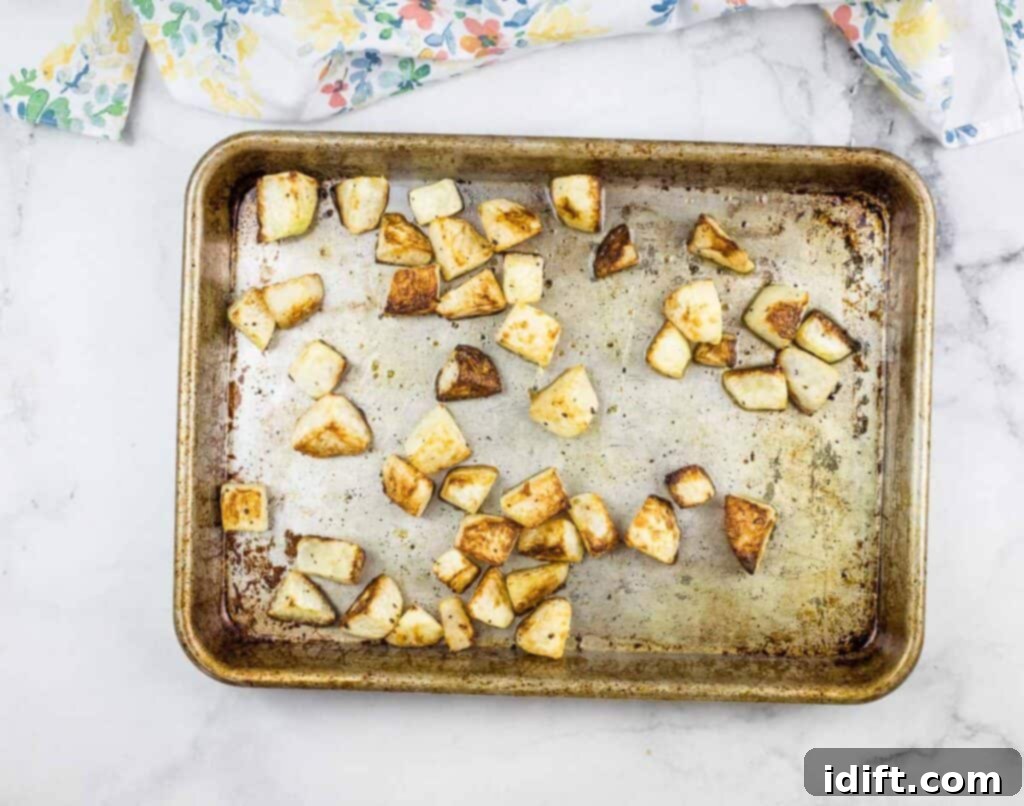 Golden Parmesan Roasted Kohlrabi 6 Cubed roasted kohlrabi on a baking sheet.