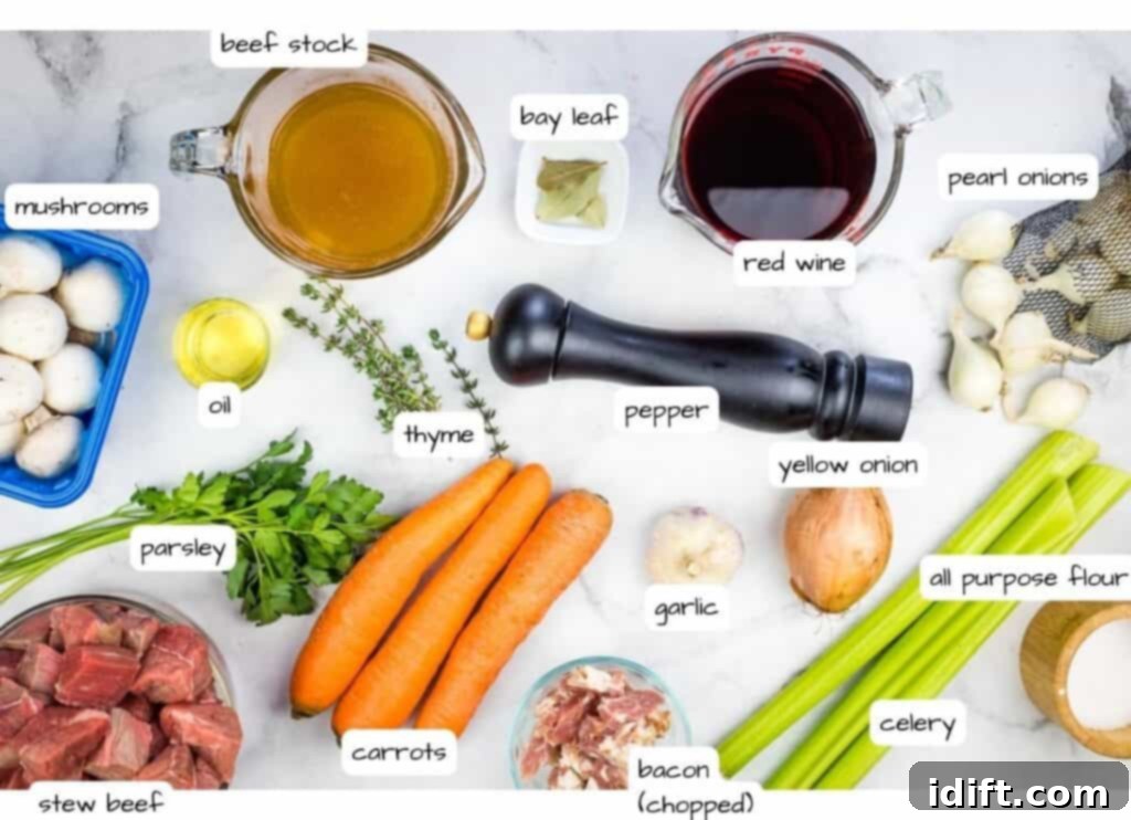 A curated display of fresh ingredients for Beef Bourguignon on a elegant marble countertop.