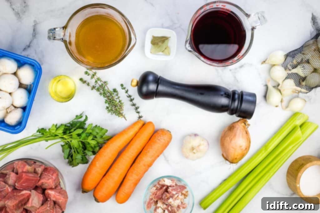 Ingredients for a beef bourguignon on a marble table.