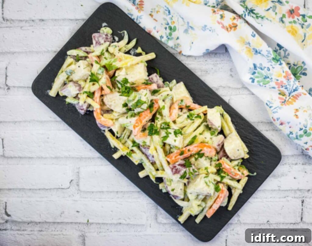 Sun-Kissed Potato and Golden Bean Salad 3 Yellow Bean & Potato Salad on a black plate.