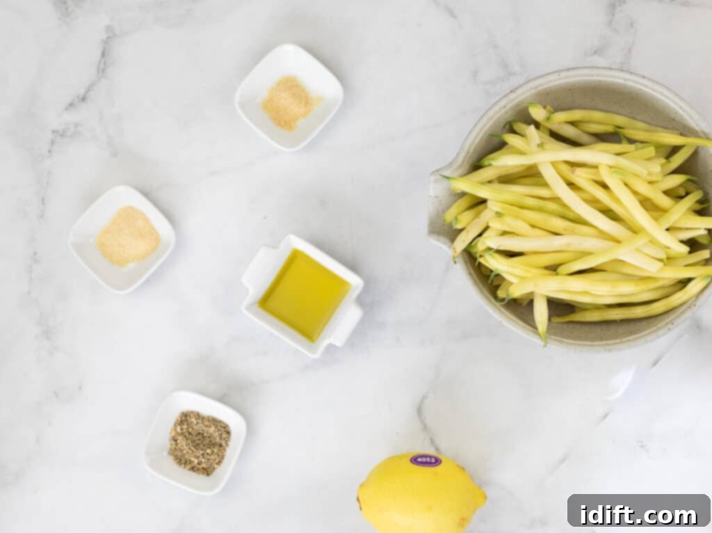 All ingredients for Air Fryer Lemon Pepper Yellow Beans laid out on a kitchen counter.