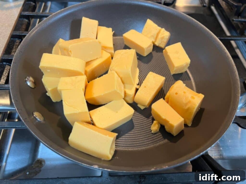 Cubes of cheese in a frying pan.