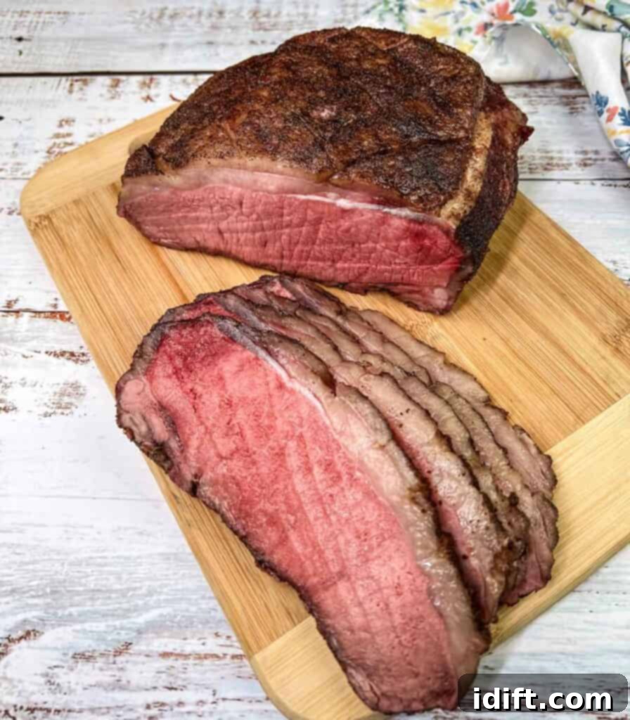 Succulent Traeger Smoked New York Strip Roast 2 Perfectly sliced Traeger Smoked New York Strip Roast, showcasing its tender, juicy interior on a cutting board, ready to be served.