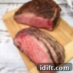 Succulent Traeger Smoked New York Strip Roast 12 Sliced Smoked New York Strip Roast on a cutting board.